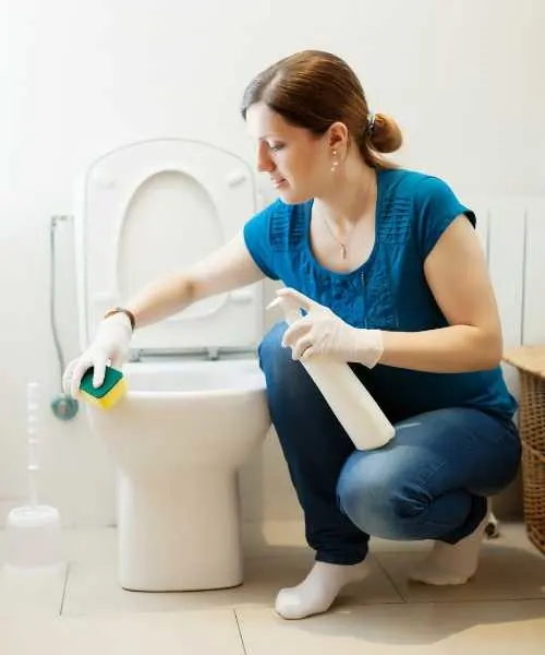A woman cleaning toilet