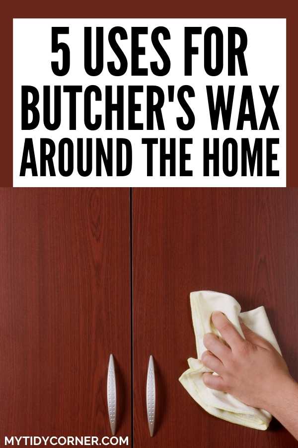 Someone polishing a wooden cabinet with a rag, which is one of the uses for Butcher's wax.