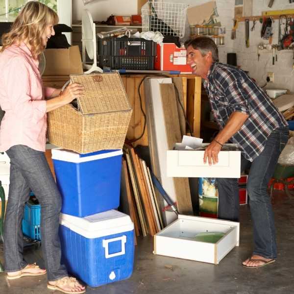 A man and woman decluttering a garage