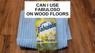 A bottle of Fabuloso on a rag on wood floor with text that says, 