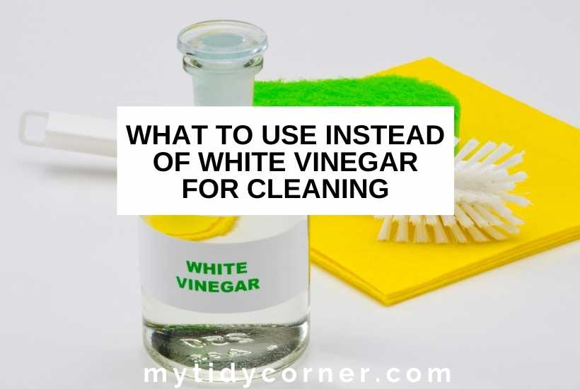Vinegar and yellow and green sponges with text that says, "What to use instead of white vinegar for cleaning".