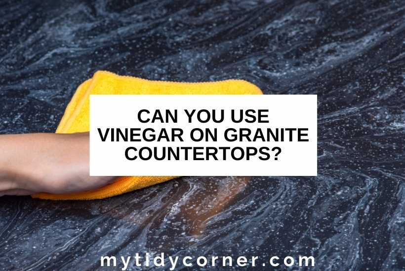 Someone cleaning a countertop with a yellow rag, with text that says, "Can you use vinegar on granite countertops?"