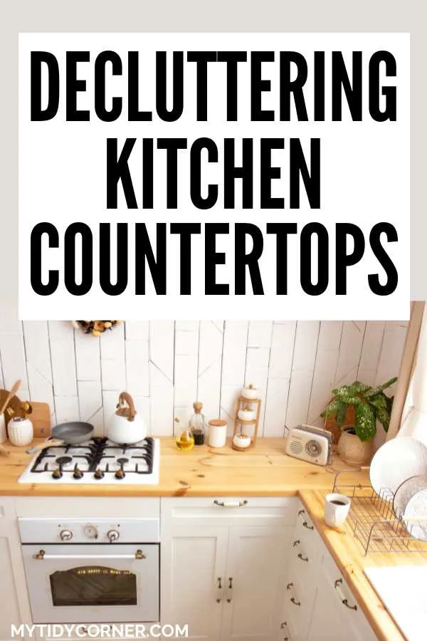 Kettle and pan on a stove, cup, plates, plant and other stuff on a counter and text that says, "Decluttering kitchen countertops".