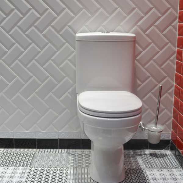 White shaped wall tiles, toilet bowl.