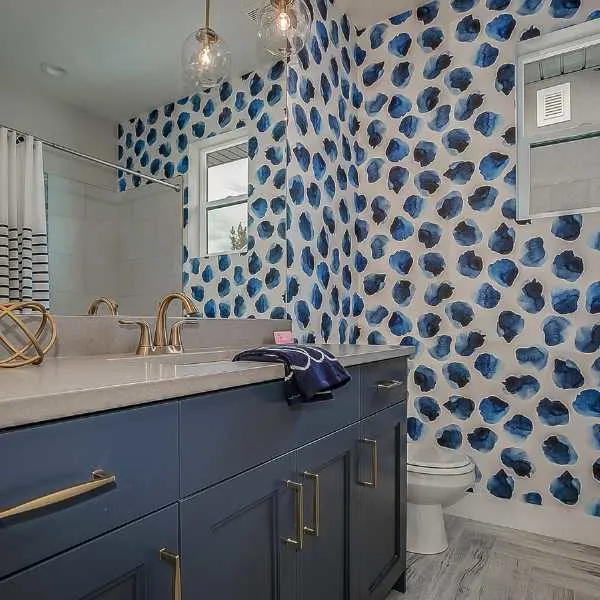 Wallpaper accent wall in a bathroom.