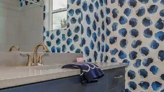 Wallpaper accent wall in a bathroom.