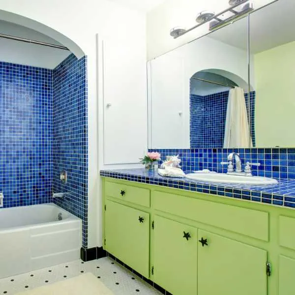 Bathroom with green cabinets and Aegean blues.