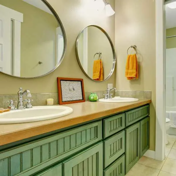 Bathroom with green cabinets