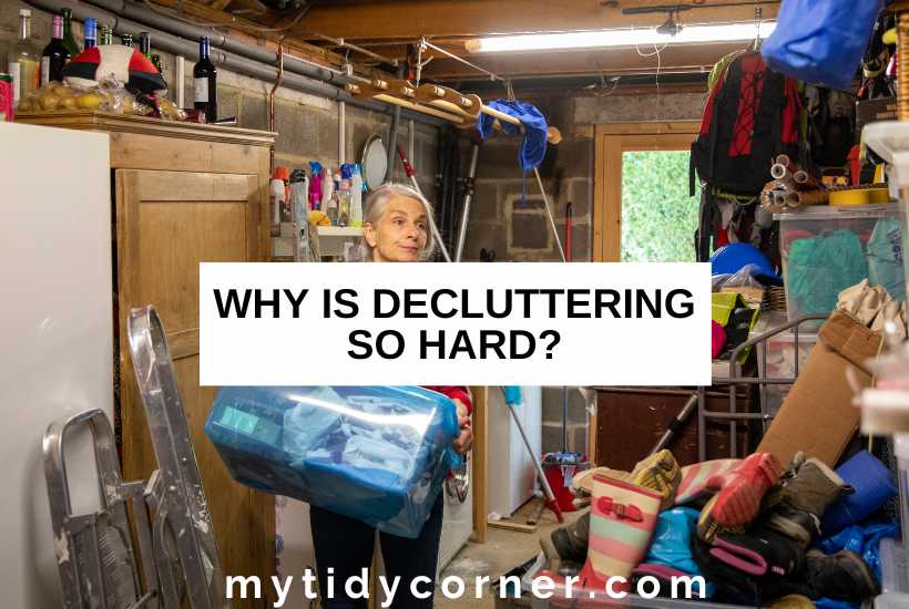 A Woman carrying a plastic bin filled with stuff in a garage and text overlay that reads, "Why is decluttering so hard?"