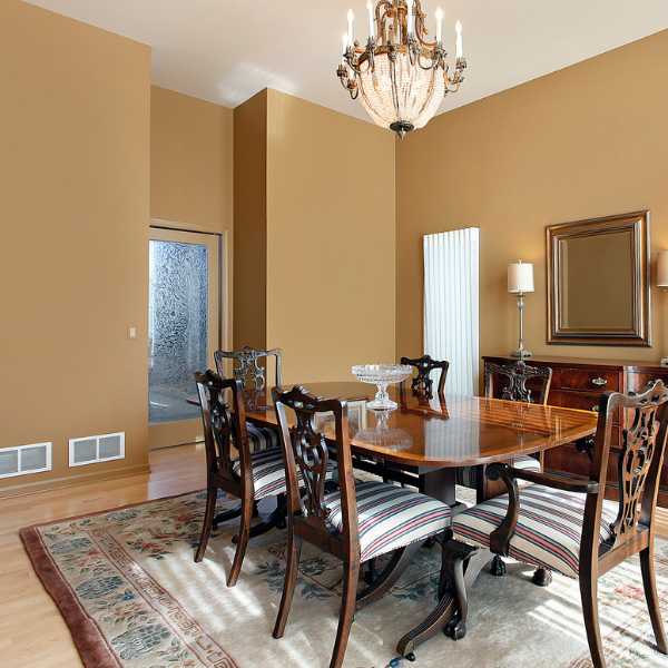 A dining room with tan walls.