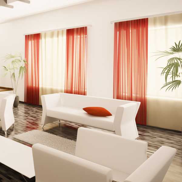 A modern room with burnt red curtains,
