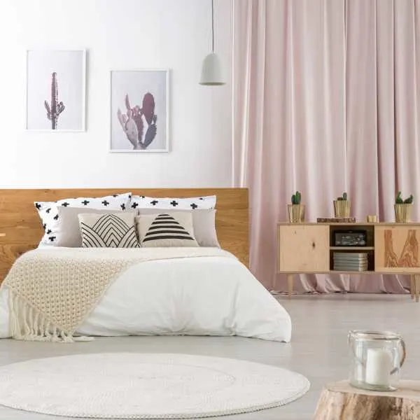 Bedroom with pastel pink curtains.