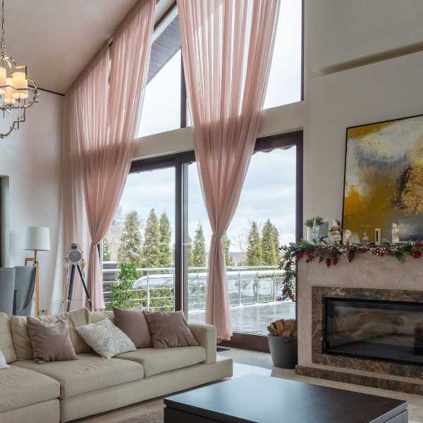 Living room with pale pink curtains.