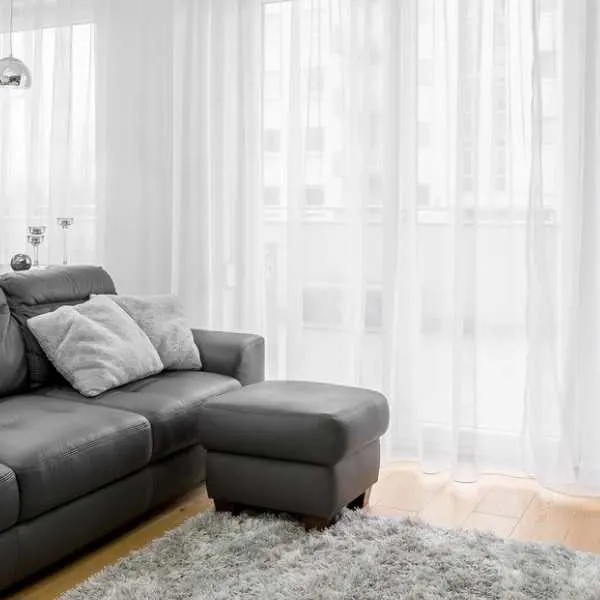 Living room with white curtains.