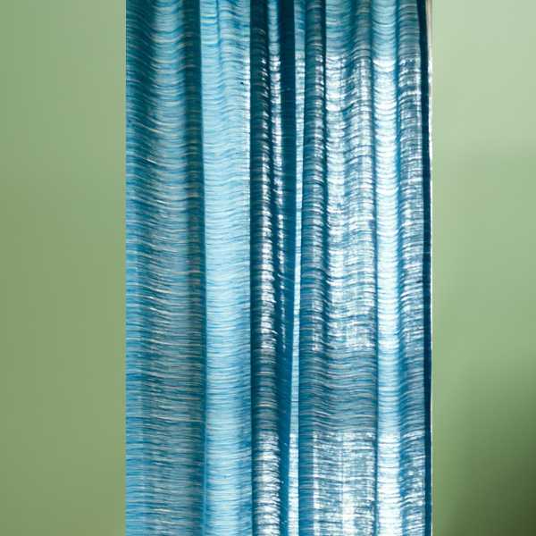 Blue curtain on green wall
