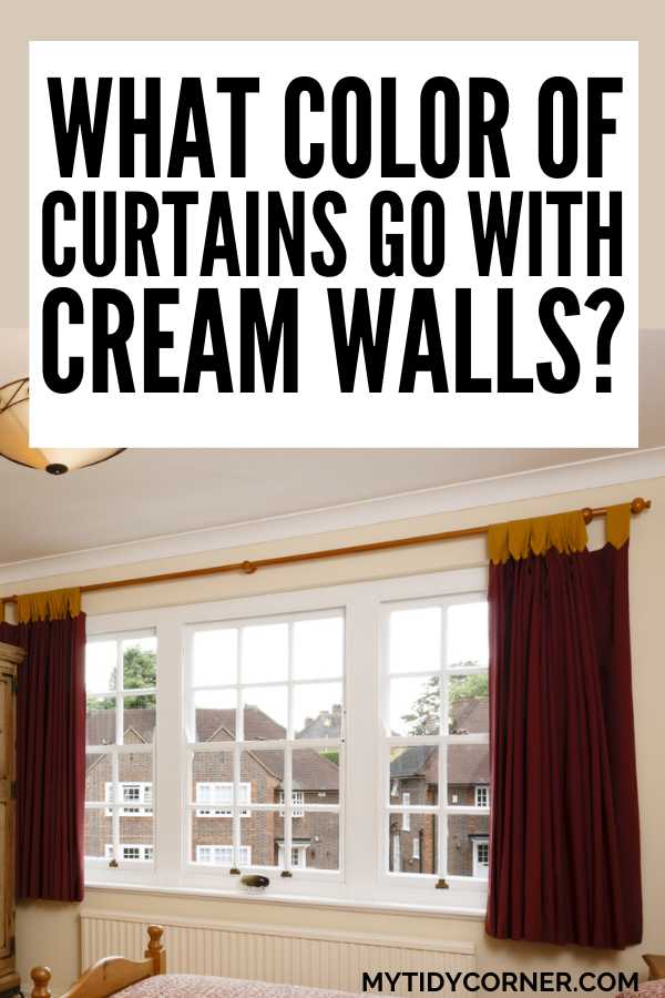 Dark red curtains over a window in a room and text overlay that reads, "What color of curtains go with cream walls?"