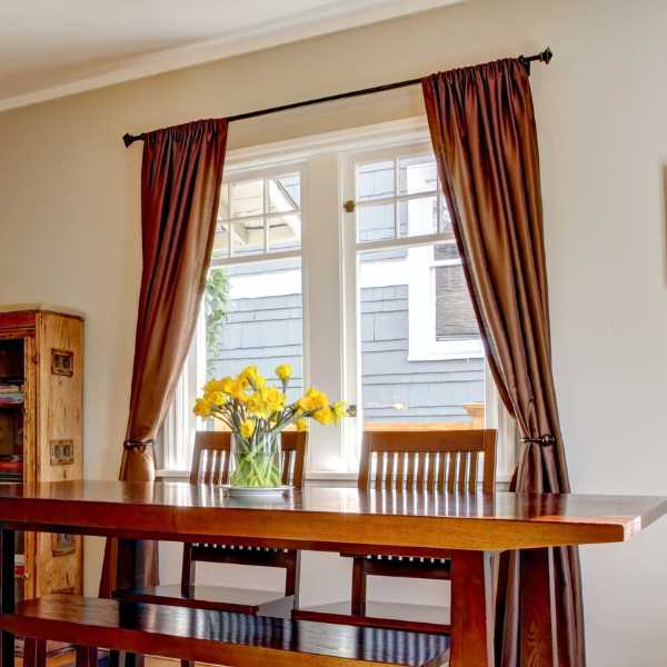 Dining room with brown curtain.