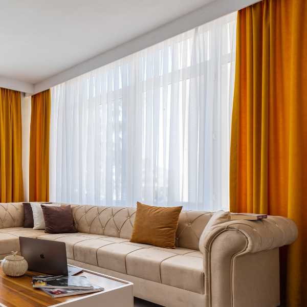 Living room with orange curtains.