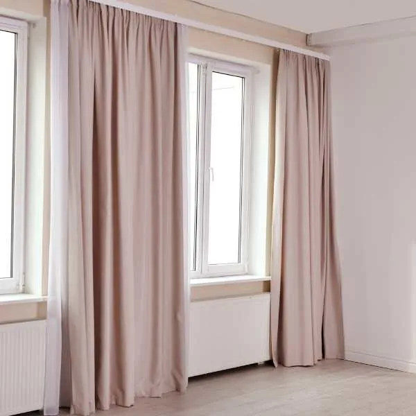 Room with pale pink curtains.