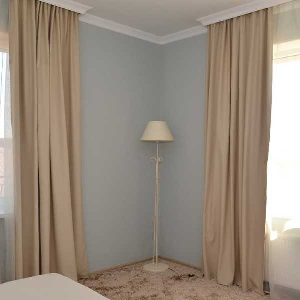 Room with tan curtains.