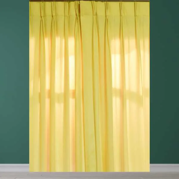 Yellow curtain on green wall.