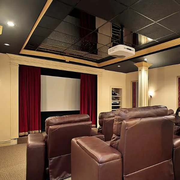 Home movie room with black ceiling.