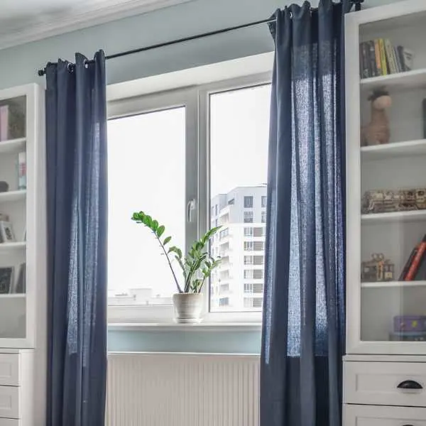 Blue curtains hanging in a standard room.