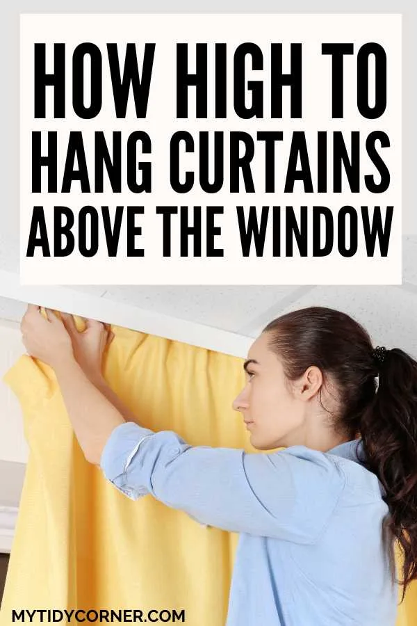 Woman hanging a yellow curtain and text overlay that reads, "How high to hang curtains above the window".