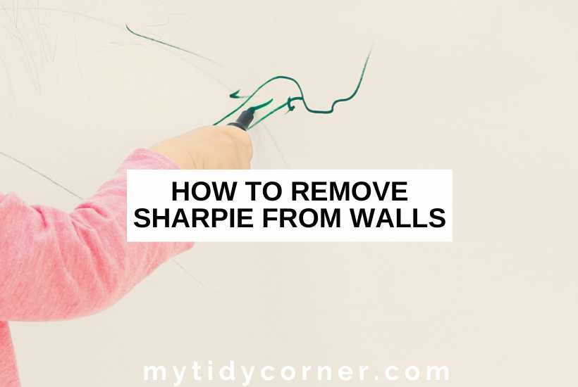 A Hand writing with a permanent marker on the wall and text overlay that reads, "How to remove Sharpie from walls".
