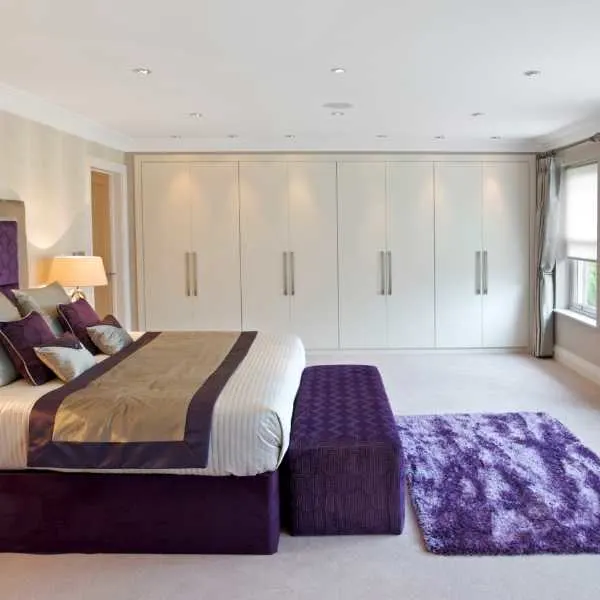 Bedroom with purple rug.