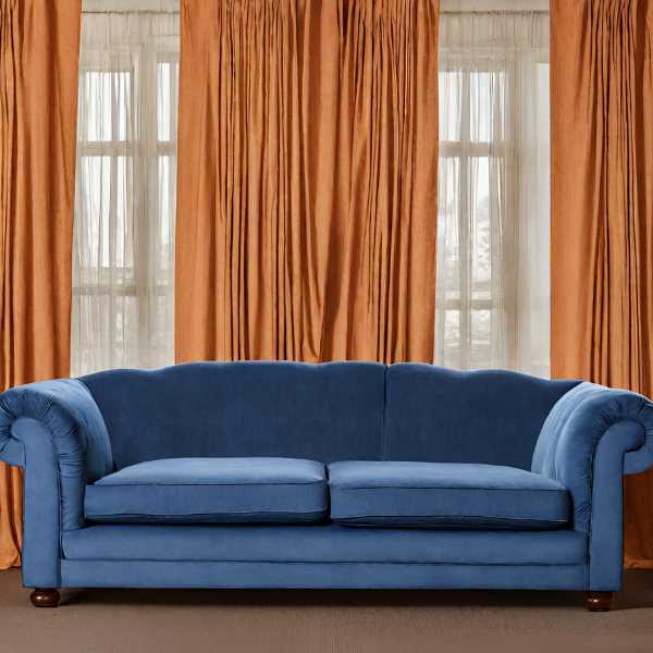 Blue couch and orange curtains.