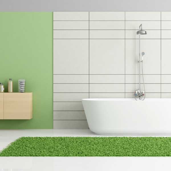 Minimalist bathroom with leaf green rug.