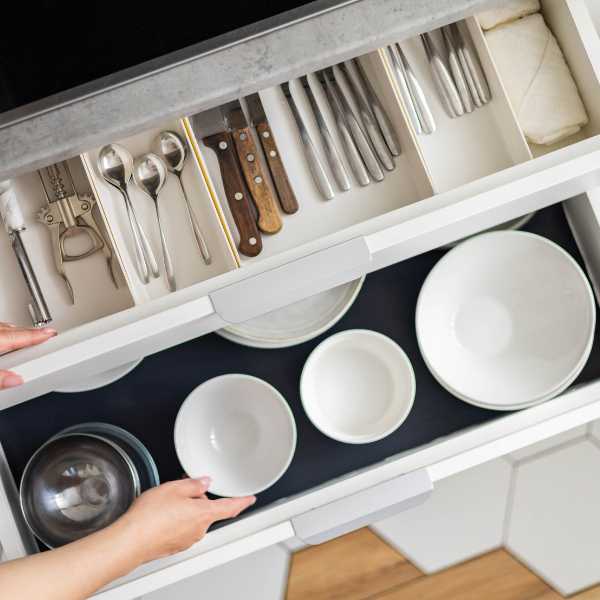 Utensils and bowls in a kitchen drawer.