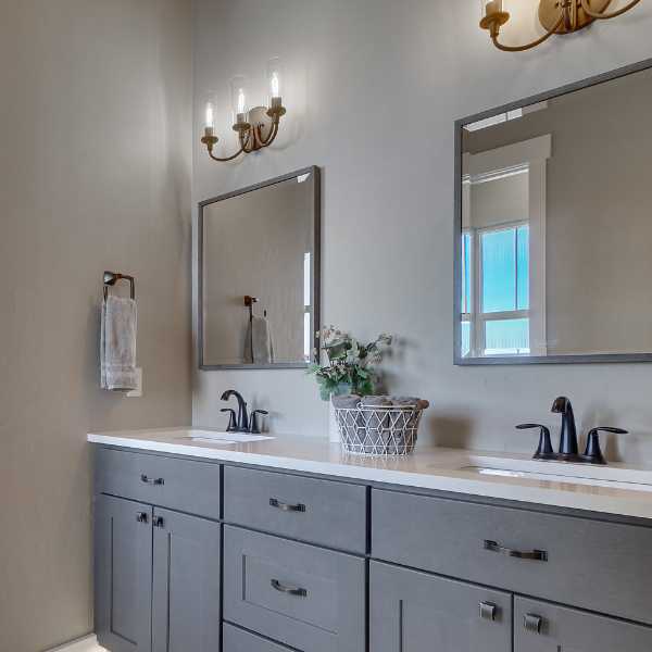 Bathroom with candle stick lighting fixtures.