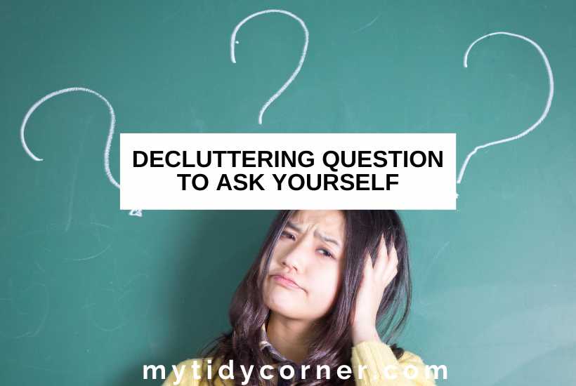 Woman holding her head, question marks on a teal wall and text overlay that reads, "Decluttering questions to ask yourself".