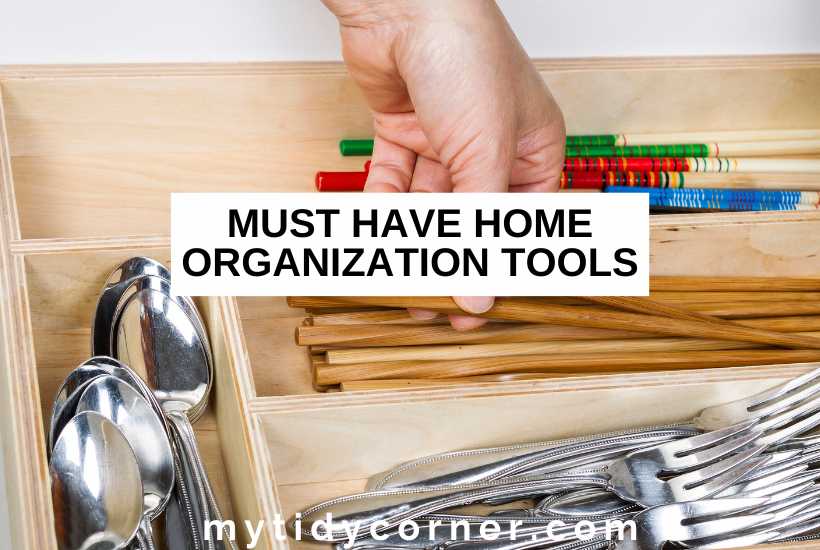A hand arranging cutlery in a drawer organizer and text overlay that reads, "Must have home organization tools".