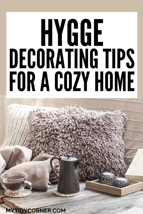 Throw pillows and blanket on a couch, tea kettle and cups and text overlay that reads, "Hygge decorating tips for a cozy home".