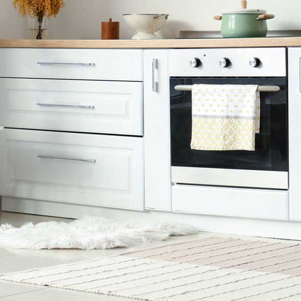 Kitchen with flat and fluffy rugs.