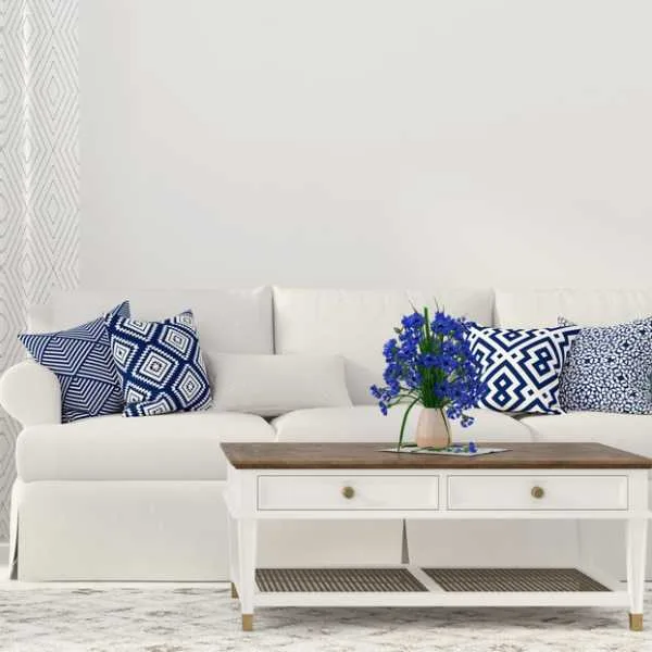Cream living room with patterned blue and white throw pillows.