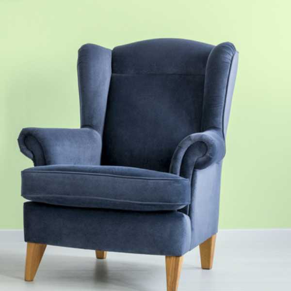 Dark blue chair and lime green wall.