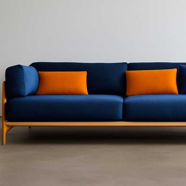 Orange throw pillows on navy blue couch.