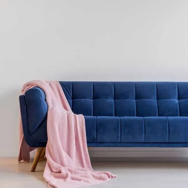 Pink throw on blue couch.