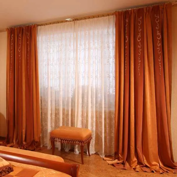 Bedroom with rust orange curtains.