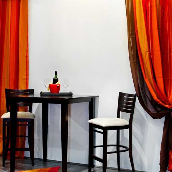 Dining room with orange curtains.