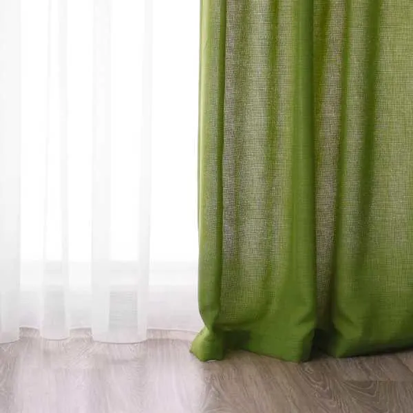 Hardwood floor white and green curtains.