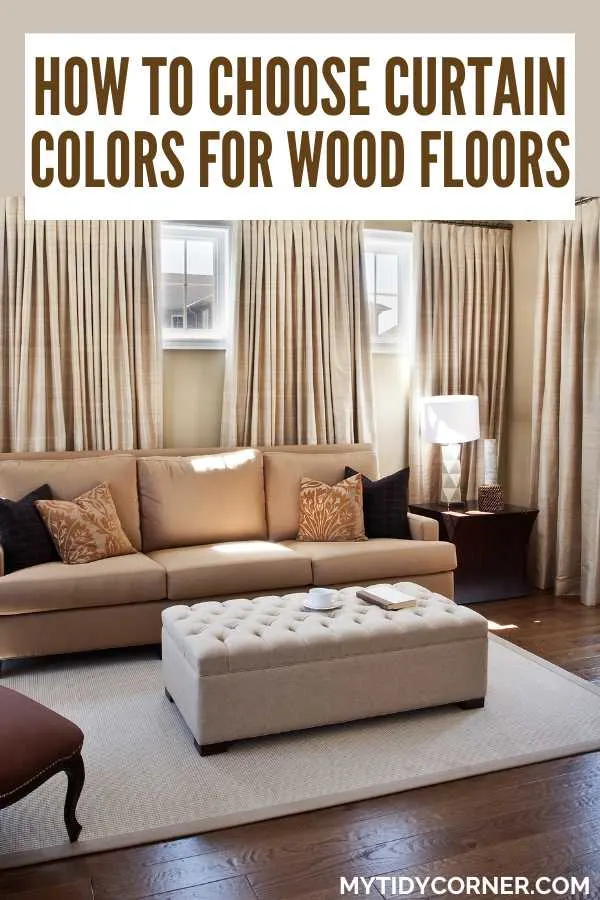 Living room with dark wood flooring and beige drapes and text overlay that says, "How to choose curtain colors for wood floors".