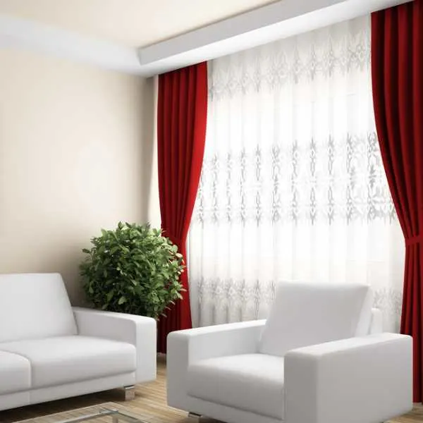 Living room with white and red curtains and white arm chairs.