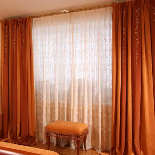 Room with burnt orange curtains.