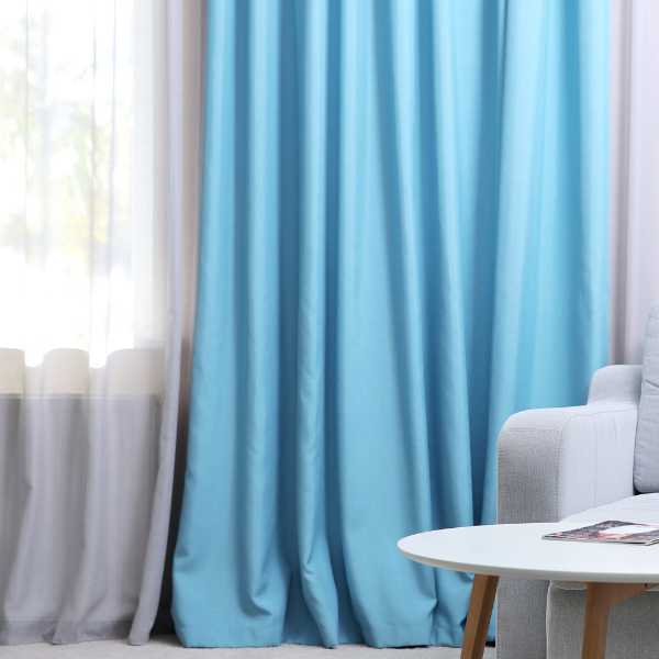 Room with white and blue curtains.