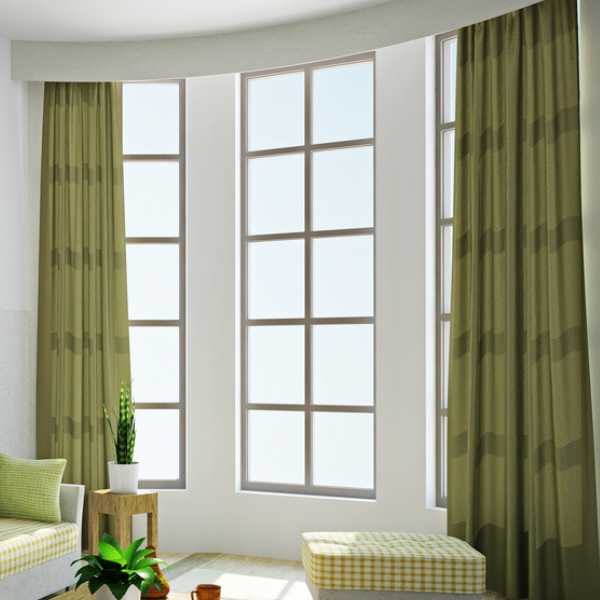Room with white walls and green curtains.